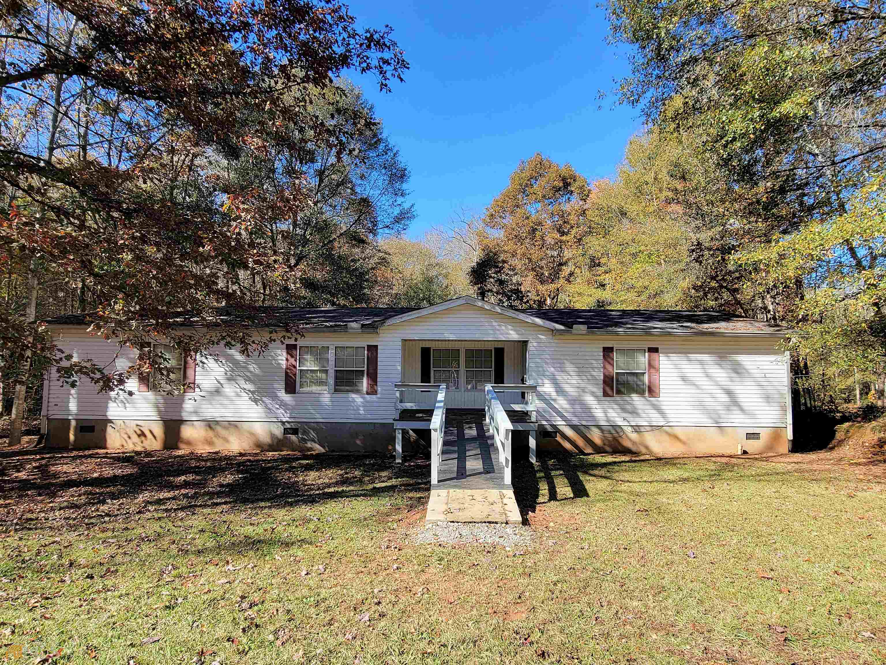 140 Fred Loggins Road Commerce, GA 30530 - Photo 1 of 1 a view of a house with a yard covered with snow in front of house
