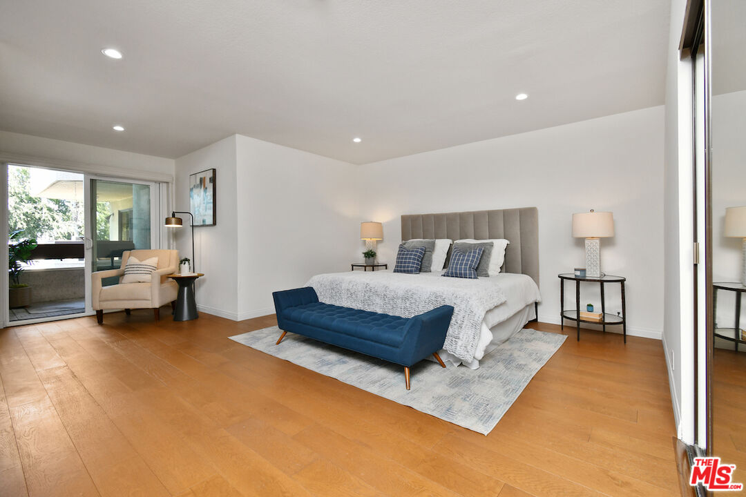 10409 Riverside Drive, Unit 204 Toluca Lake, CA 91602 - Photo 19 of 36 a bed room with a bed and a couch