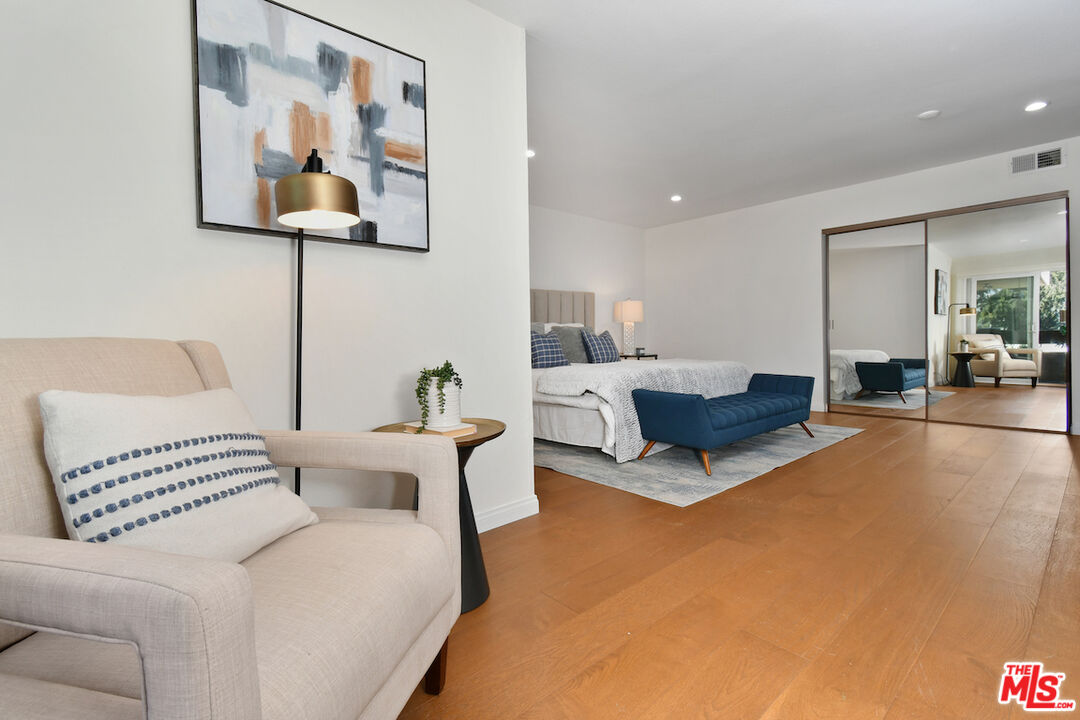 10409 Riverside Drive, Unit 204 Toluca Lake, CA 91602 - Photo 21 of 36 a living room with furniture and a lamp
