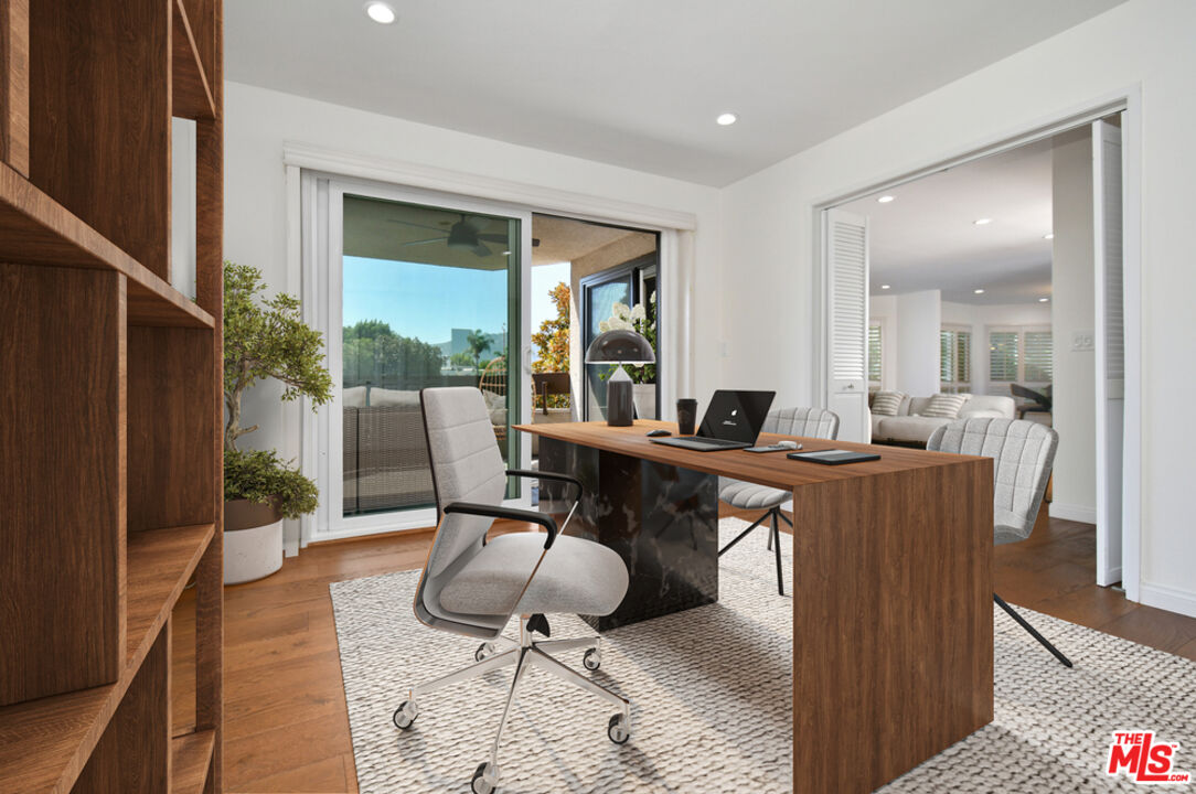 10409 Riverside Drive, Unit 204 Toluca Lake, CA 91602 - Photo 26 of 36 a workspace with wooden floor and furniture