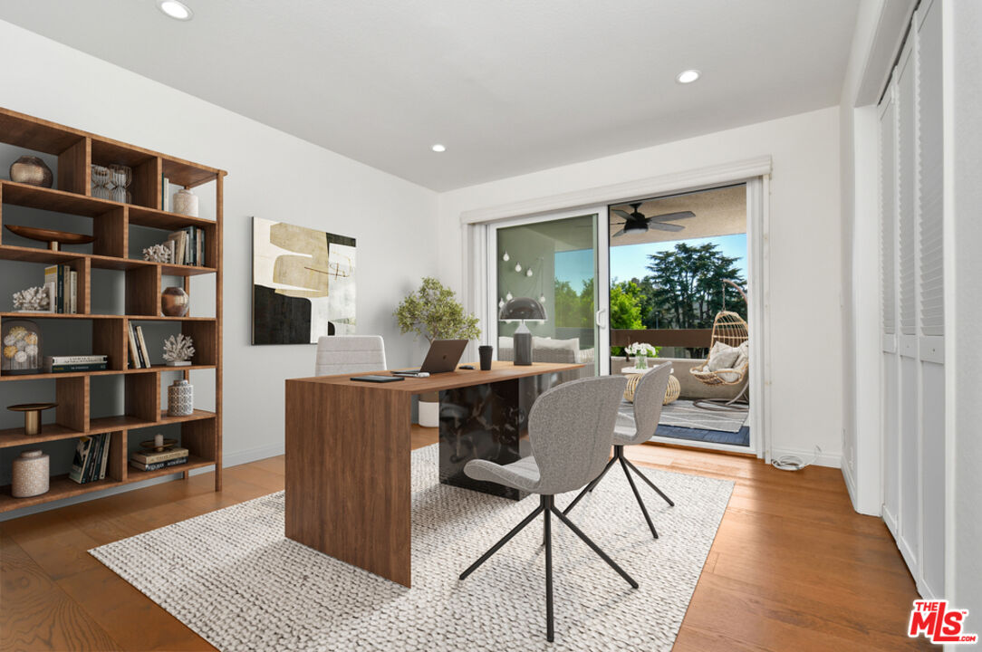 10409 Riverside Drive, Unit 204 Toluca Lake, CA 91602 - Photo 27 of 36 a living room with furniture and a book shelf