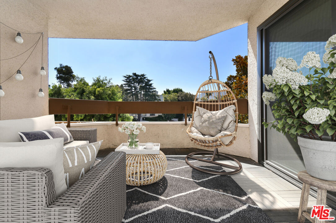 10409 Riverside Drive, Unit 204 Toluca Lake, CA 91602 - Photo 28 of 36 a living room with furniture and flowers