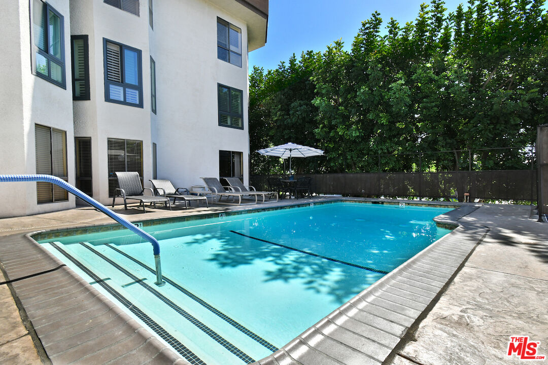 10409 Riverside Drive, Unit 204 Toluca Lake, CA 91602 - Photo 35 of 36 a view of a pool with a patio