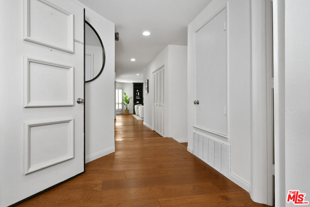 10409 Riverside Drive, Unit 204 Toluca Lake, CA 91602 - Photo 5 of 36 a view of a hallway with wooden floor and staircase