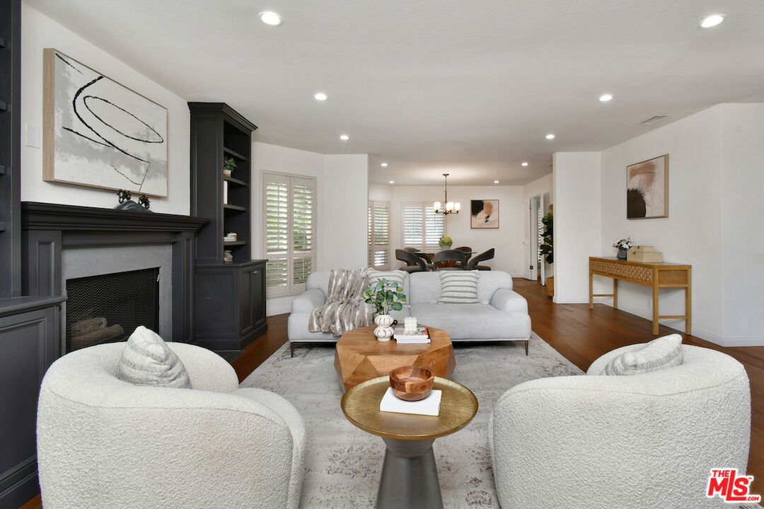 10409 Riverside Drive, Unit 204 Toluca Lake, CA 91602 - Photo 6 of 36 a living room with furniture and a fireplace