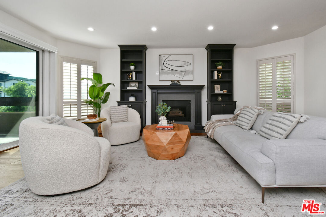 10409 Riverside Drive, Unit 204 Toluca Lake, CA 91602 - Photo 7 of 36 a living room with furniture and a fireplace