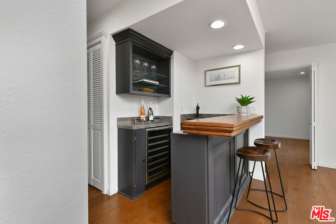 10409 Riverside Drive, Unit 204 Toluca Lake, CA 91602 - Photo 10 of 36 a kitchen with stainless steel appliances kitchen island a stove and a microwave