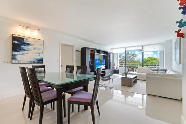a view of a dining room with furniture and a large window