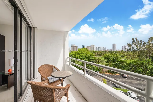 a view of a balcony with chair and table