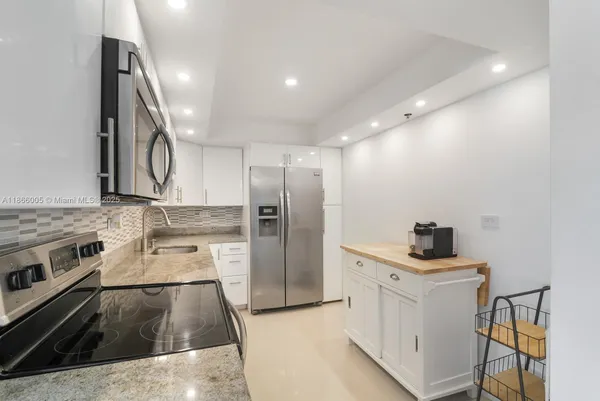 a kitchen with a sink stove and refrigerator