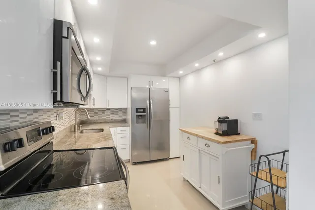 a kitchen with a sink stove and refrigerator