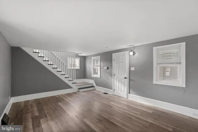 a view of entryway and hall with wooden floor