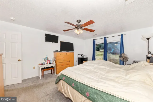 a bedroom with furniture and chandelier