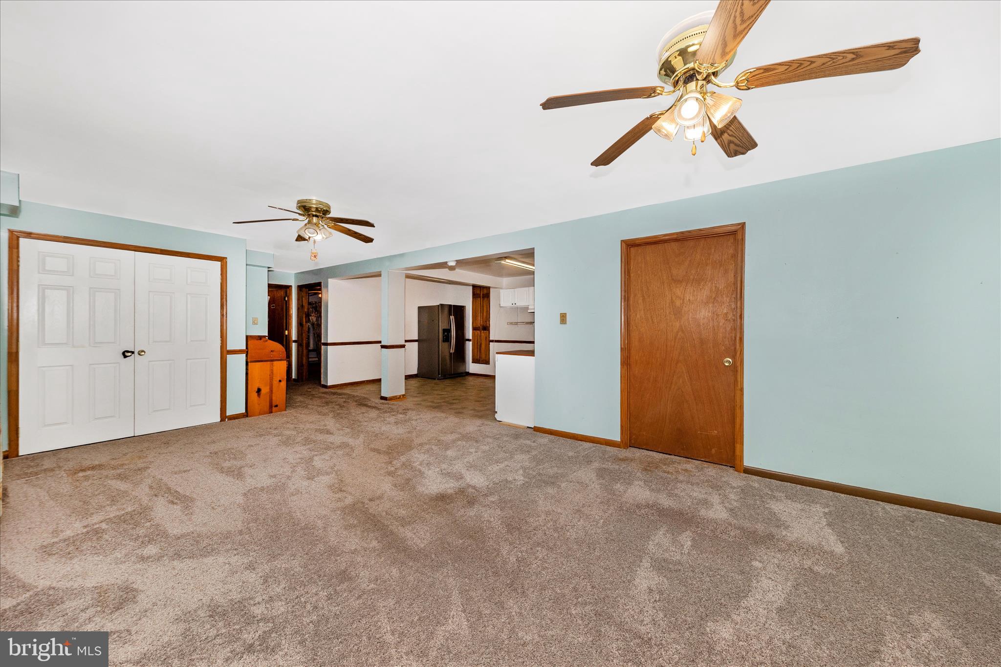 2915 Fry Road Jefferson, MD 21755 - Photo 38 of 66 a view of a livingroom with a ceiling fan and kitchen space