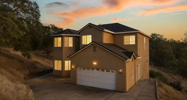 a front view of a house with a yard and garage