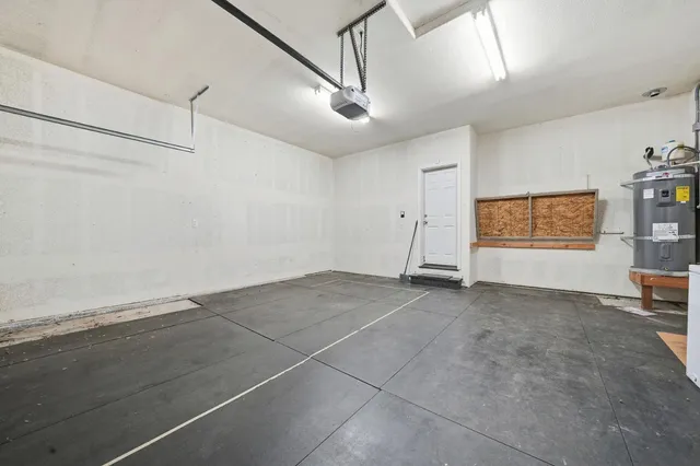 a view of house with yard and trees in the background