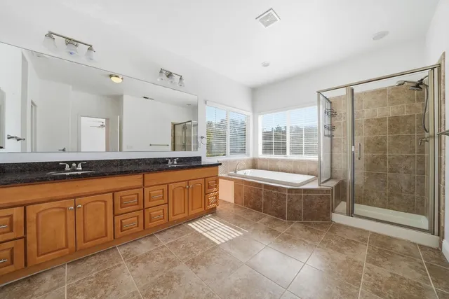 a bathroom with a tub and a shower