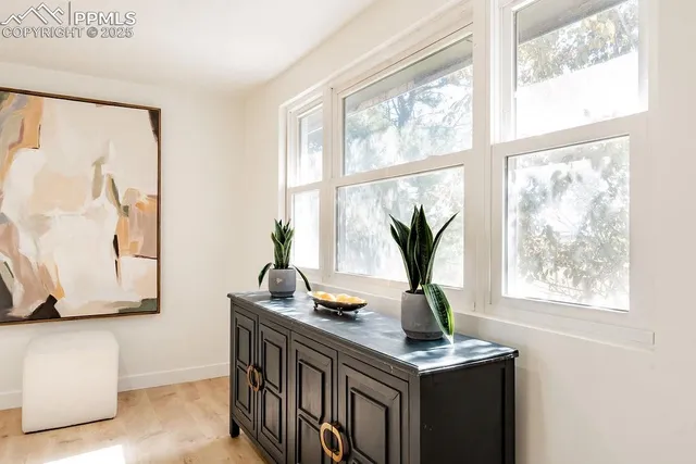a living room with lots of furniture and a large window