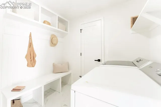 a view of a livingroom with furniture and stairs