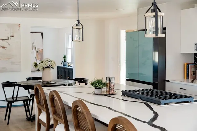 a dining room with furniture and chandelier
