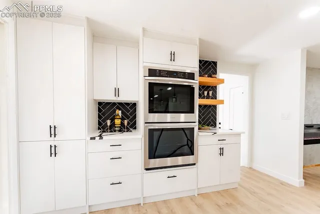 a kitchen with stainless steel appliances a stove a microwave and cabinets