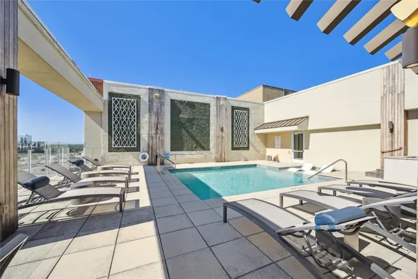 a view of a patio with a table and chairs and potted plants