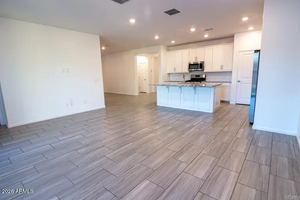 an open kitchen with kitchen island and a sink