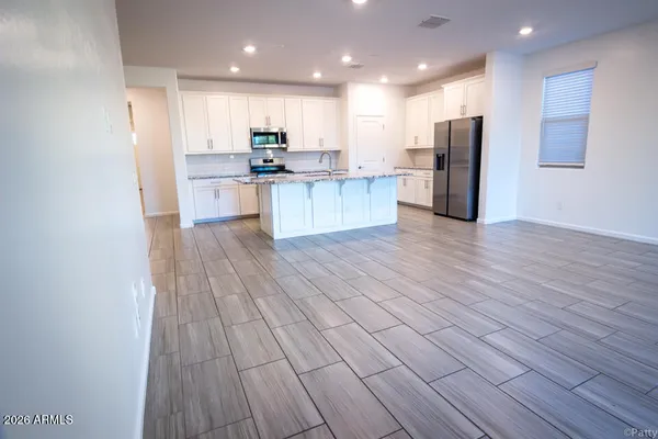 a view of kitchen view wooden cabinets and stainless steel appliances