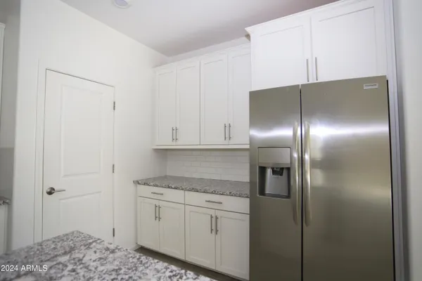 a kitchen with cabinets and stainless steel appliances