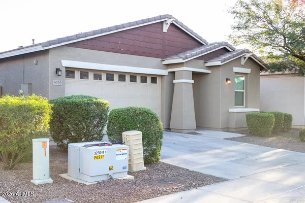 a view of a house with backyard and sitting area