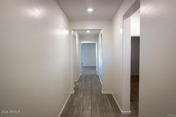 a view of a hallway with wooden floor