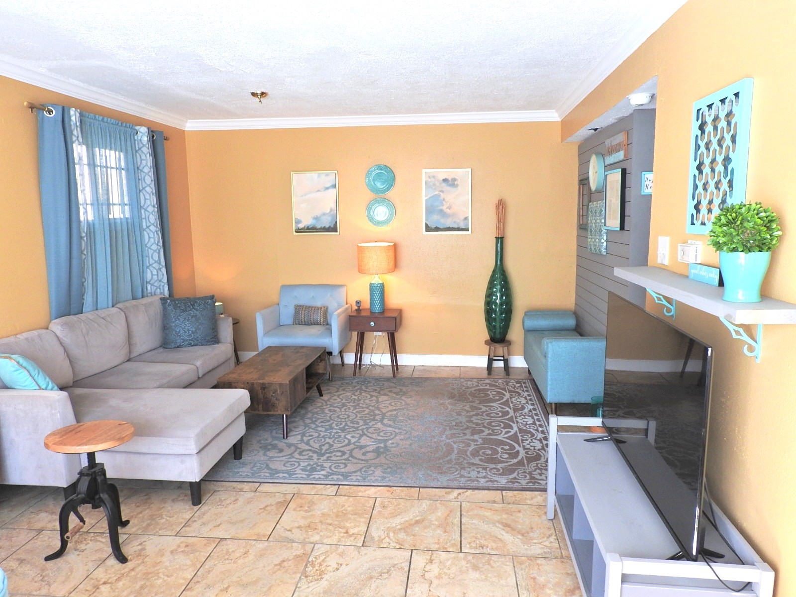 a living room with furniture and a flat screen tv