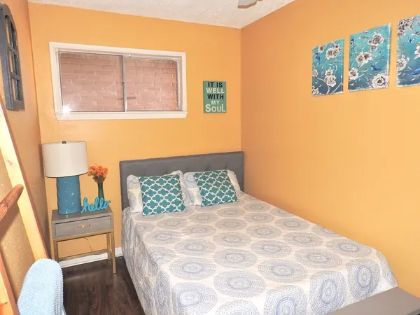 a bedroom with a bed and a window