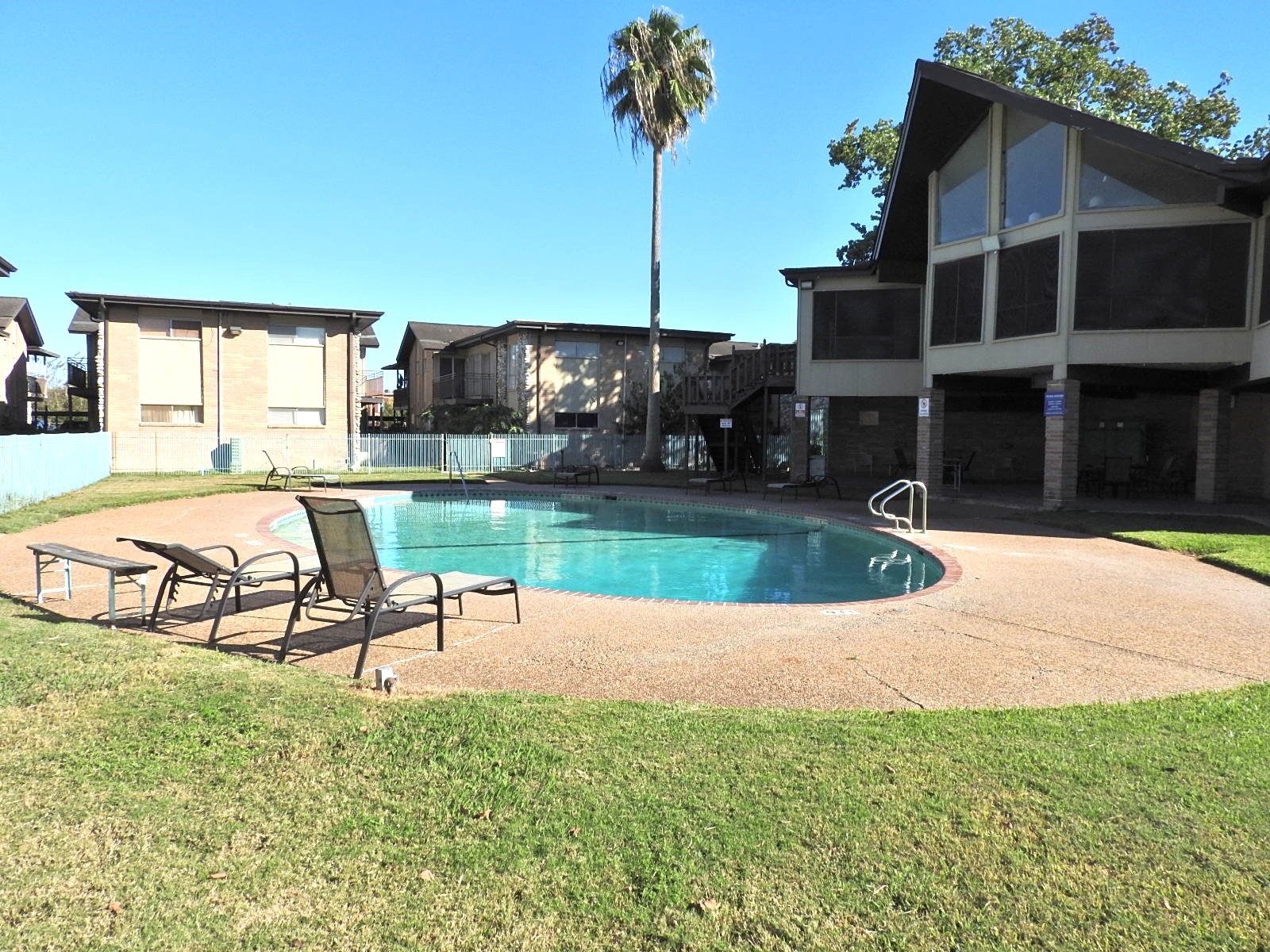 7047 Bissonnet Street, Unit 44 Houston, TX 77074 - Photo 19 of 20 a view of a swimming pool with a yard and sitting area
