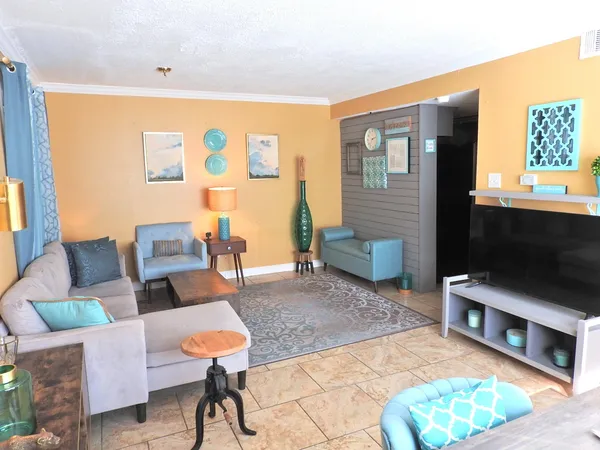 a living room with furniture and a flat screen tv