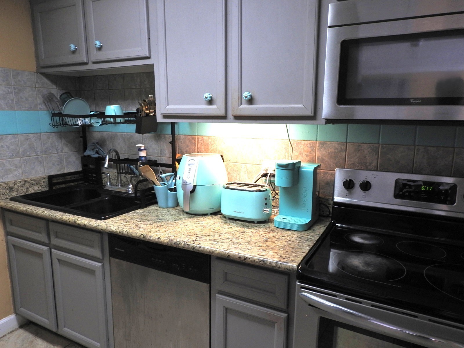 7047 Bissonnet Street, Unit 44 Houston, TX 77074 - Photo 6 of 20 a kitchen with granite countertop cabinets and steel stainless steel appliances