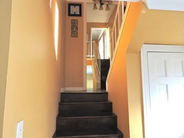 a view of staircase with white walls and a window