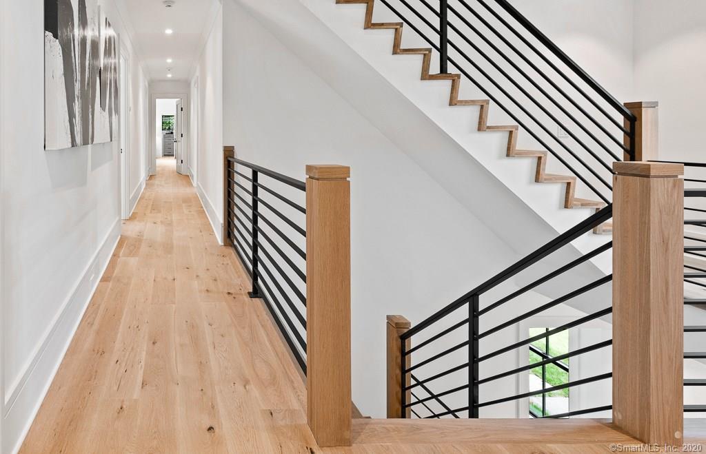 1 Deerfield Road Darien, CT 06820 - Photo 20 of 40 a view of a hallway with wooden floor and staircase