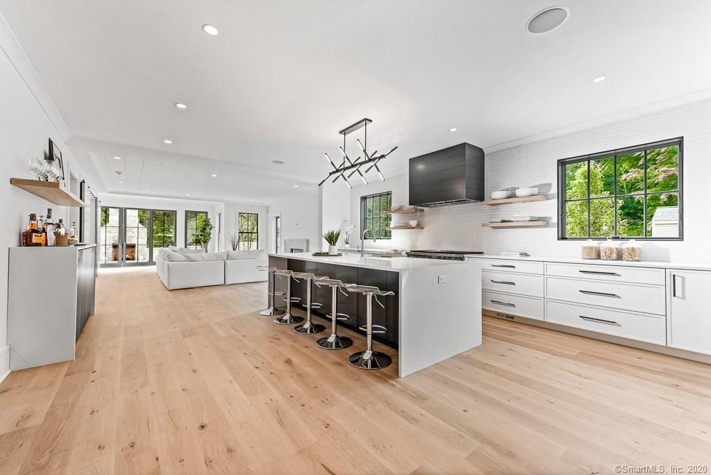 1 Deerfield Road Darien, CT 06820 - Photo 3 of 40 a kitchen with stainless steel appliances a stove top oven and a wooden floor