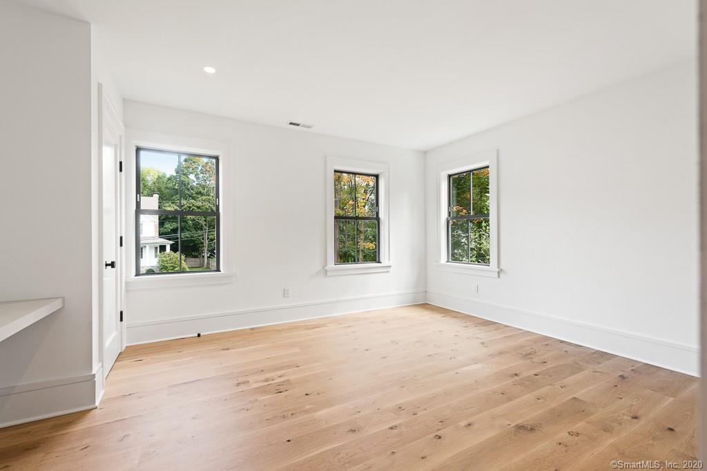 1 Deerfield Road Darien, CT 06820 - Photo 28 of 40 an empty room with wooden floor and windows