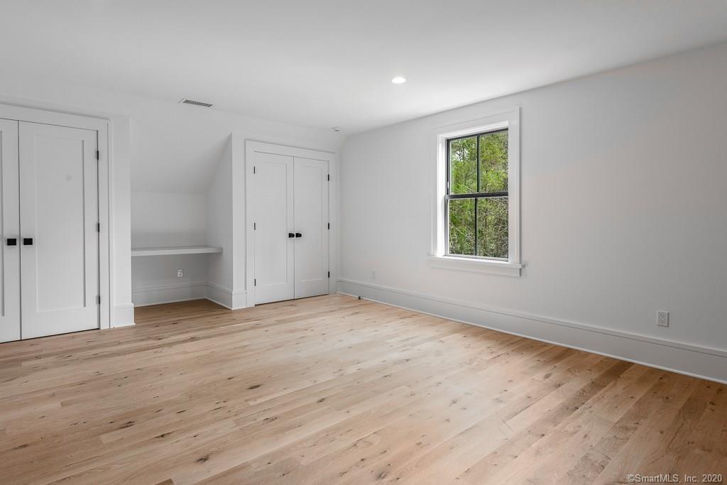 1 Deerfield Road Darien, CT 06820 - Photo 30 of 40 an empty room with wooden floor and windows