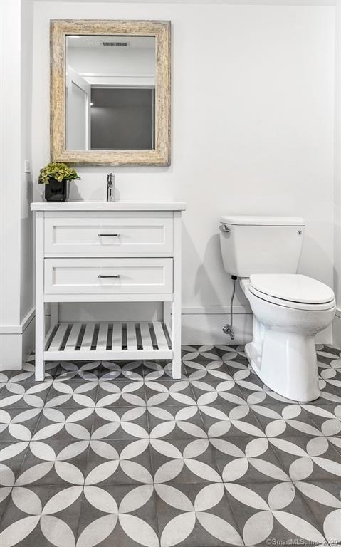 1 Deerfield Road Darien, CT 06820 - Photo 32 of 40 a bathroom with a sink toilet and mirror