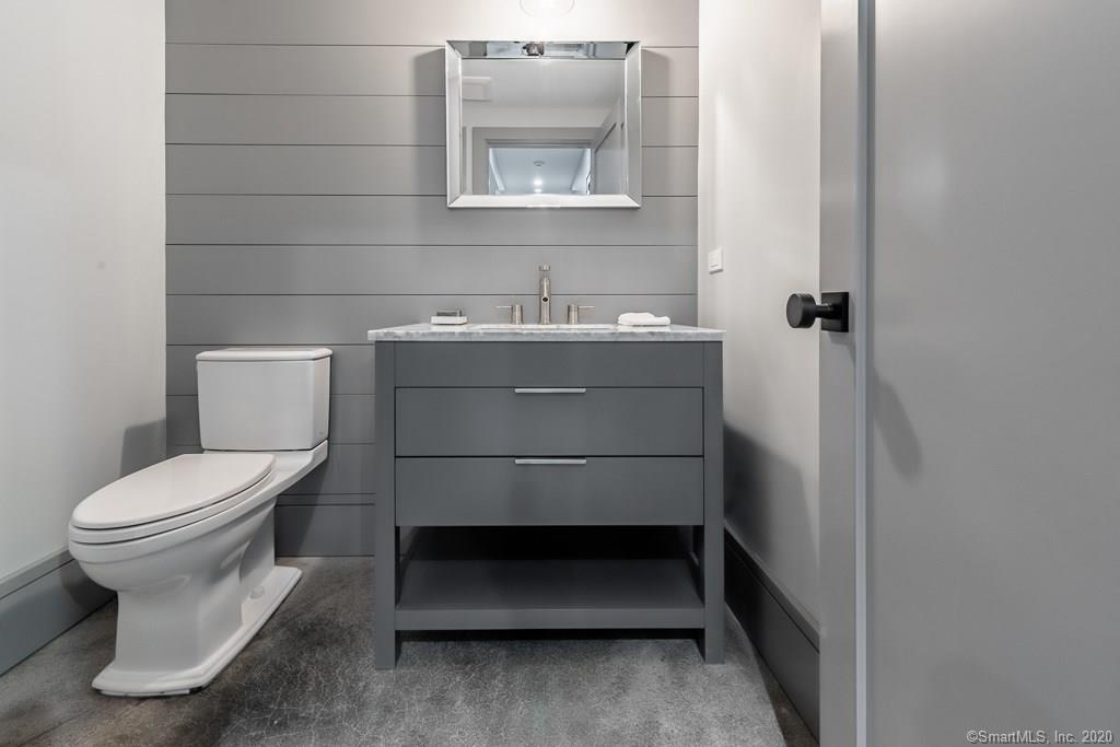 1 Deerfield Road Darien, CT 06820 - Photo 36 of 40 a bathroom with a toilet sink and mirror