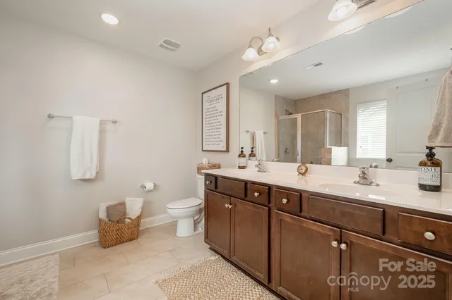 a bedroom with a bed a window and a dresser