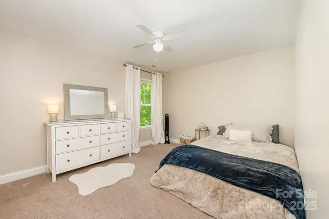 a bathroom with a sink a toilet a mirror and shower