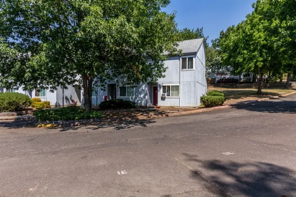a front view of a house with a yard and a garage