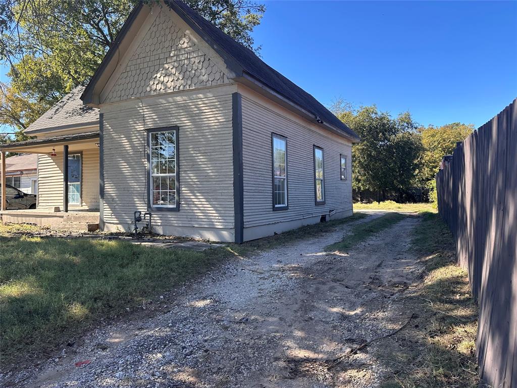 115 1st Street Terrell, TX 75160 - Photo 2 of 9 a view of a house with backyard and trees