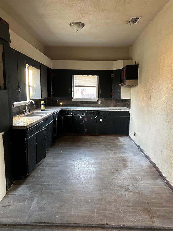 115 1st Street Terrell, TX 75160 - Photo 7 of 9 a large kitchen with stainless steel appliances granite countertop a sink counter space and a window