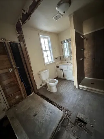 a bathroom with a sink toilet and shower