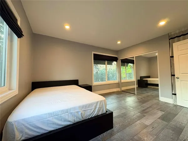 a spacious bedroom with a large bed and a couch